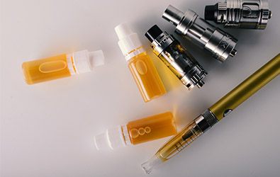 bottles of e-liquids and an electronic cigarette